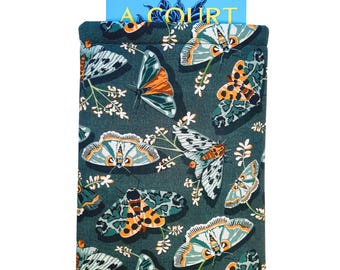 May include: A book sleeve with a dark teal background and a pattern of butterflies in shades of orange, teal, and white. The book sleeve is holding a book with the title "A COURT" visible on the cover.