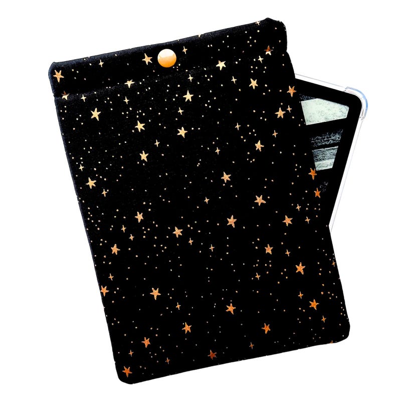 A black with gold metallic stars pouch with a  gold snap for a kindle paper white.  A kindle is peaking out from behind the sleeve.