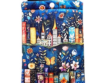 May include: A blue fabric phone sleeve with a fantasy design of a castle, flowers, butterflies, and books. The sleeve has a dark blue background with colourful illustrations. The top edge is folded over, and a phone is visible inside.