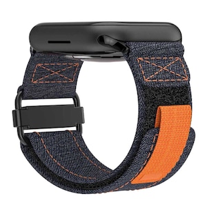May include: A black and blue denim watch band with an orange adjustable strap. The band is compatible with Apple Watch.