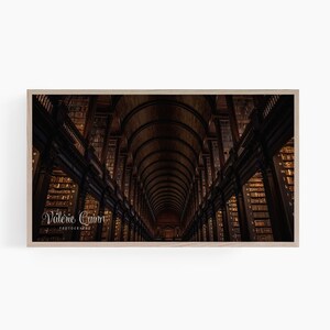 May include: A dark, wood-panelled library with high arched ceilings and rows of bookshelves. The shelves are filled with books, and the light from the windows casts long shadows across the room. The text "Valerie Quinn Photography" is visible in the bottom left corner.