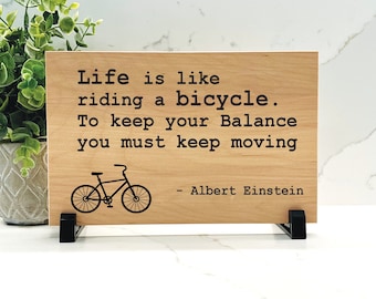 Life is like riding a bicycle. To keep your balance you must keep moving - Albert Einstein Quote - Choice of wood color - Inspirational sign