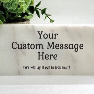 May include: White marble rectangular block with the text "Your Custom Message Here (We will lay it out to look best!)" engraved in black.
