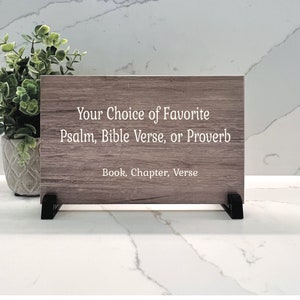 Pode incluir: Uma placa de madeira com o texto "Your Choice of Favorite Psalm, Bible Verse, or Proverb" e "Book, Chapter, Verse" em texto branco.