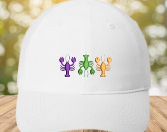 May include: White baseball cap featuring three embroidered lobsters in purple, green, and orange. The lobsters are arranged horizontally across the front of the cap. The cap has a curved brim and a structured crown.