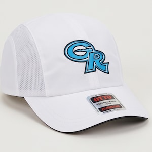 May include: A white performance baseball cap featuring a blue and black embroidered GR logo on the front. The cap has side mesh panels and a sticker on the brim that reads OTTO PERFORMANCE OSFM RUNNING PREMIUM SOFT FABRIC.