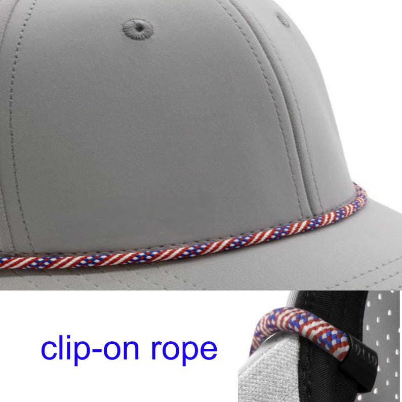 May include: A light grey baseball cap featuring a decorative twisted rope trim in red, white, and blue colours. The cap includes a detachable clip-on rope accessory, as indicated by the text clip-on rope, which attaches to the side of the hat.