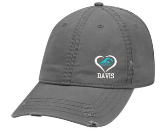May include: Gray distressed baseball cap with a white heart and a blue wave graphic. The text "DAVIS" is embroidered below the heart.