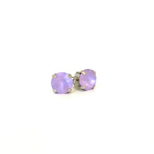 May include: A pair of silver stud earrings with lavender-colored round stones.