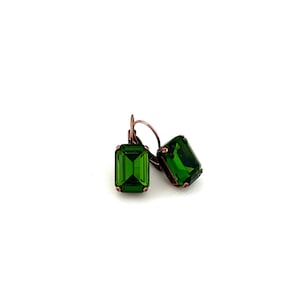 May include: A pair of emerald green gemstone earrings with copper-toned leverback closures.