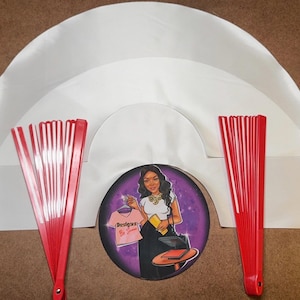 May include: Three white satin fabric fan shapes, two red and white folding fans, and a sticker with a woman wearing a shirt that says "Boss Babe" in a purple and black background.