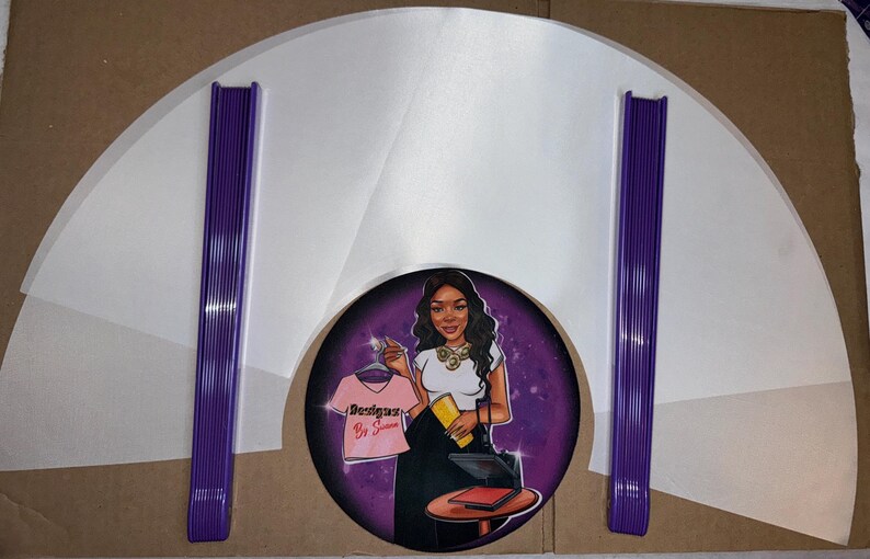 May include: A set of white heat press transfer sheets with purple heat press tools. The sheets are in a fan shape and the tools are stacked together. The image also includes a purple circle with a cartoon illustration of a woman with a heat press and the text "Designs By Sienna".