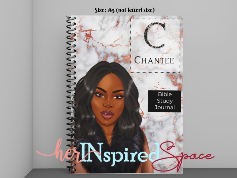 May include: A spiral-bound Bible study journal with a marble and rose gold cover design. The cover features an illustration of a woman with long black hair and the name "CHANTEE". The journal also includes the text "Bible Study Journal".