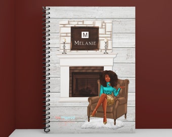 May include: Spiral-bound notebook featuring a digital illustration of a woman seated in a brown armchair in front of a fireplace. The fireplace has a white mantel and a sign that says "Melanie". The background is a white wood panel design.