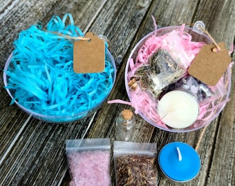 May include: Two clear glass bowls filled with blue and pink shredded paper, a small clear glass bottle, two small clear plastic bags containing pink and brown herbs, and a blue tealight candle.