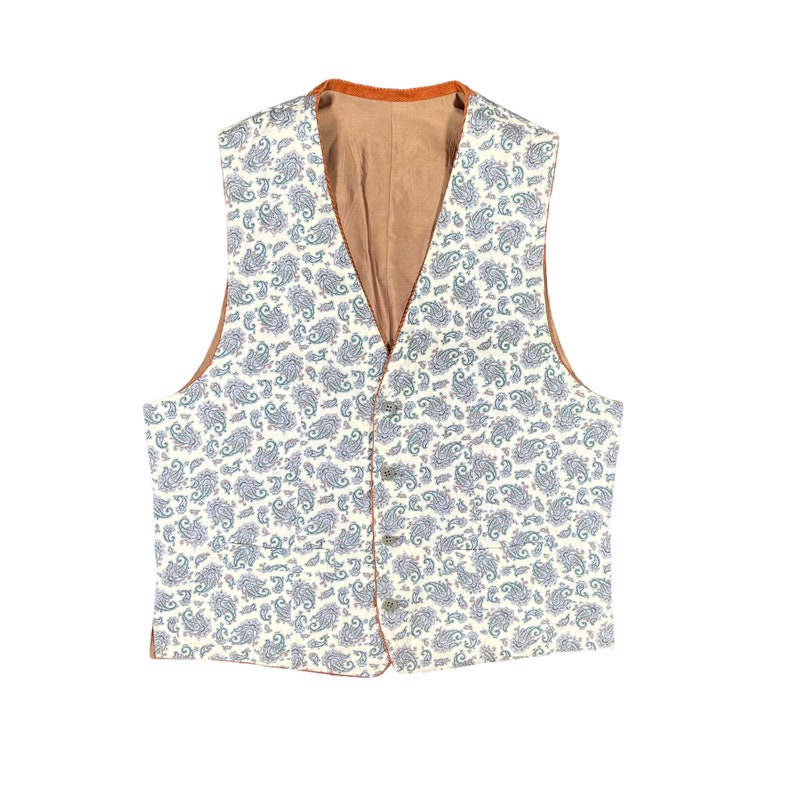May include: A cream-colored vest with a paisley pattern in shades of blue and green. The vest has a brown lining and trim, with four buttons down the front. A classic, tailored garment.