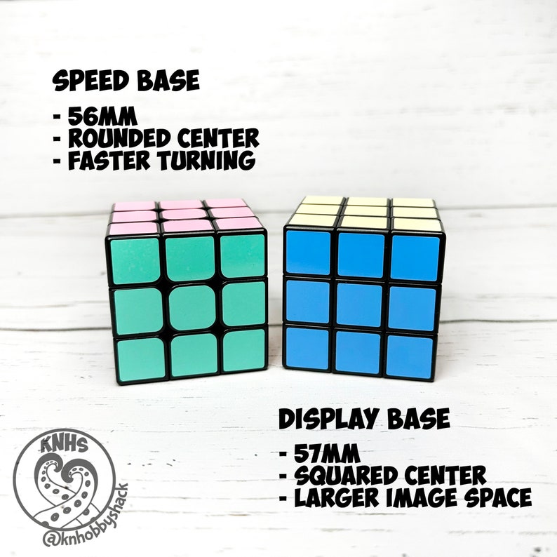 May include: Two 3x3 Rubik's Cubes on different bases. The left cube is on a 56mm speed base with rounded corners. The right cube is on a 57mm display base with squared corners. The speed base is designed for faster turning, while the display base provides more space for a larger image.