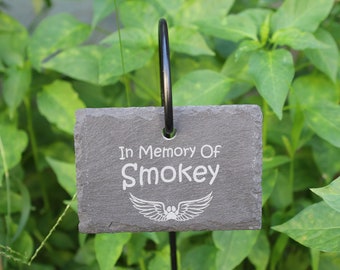 May include: A black slate garden marker with the text "In Memory Of Smokey" and a white paw print with wings.