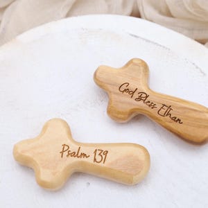 May include: Two wooden crosses with engraved text. One cross reads "God Bless Ethan" and the other reads "Psalm 139".
