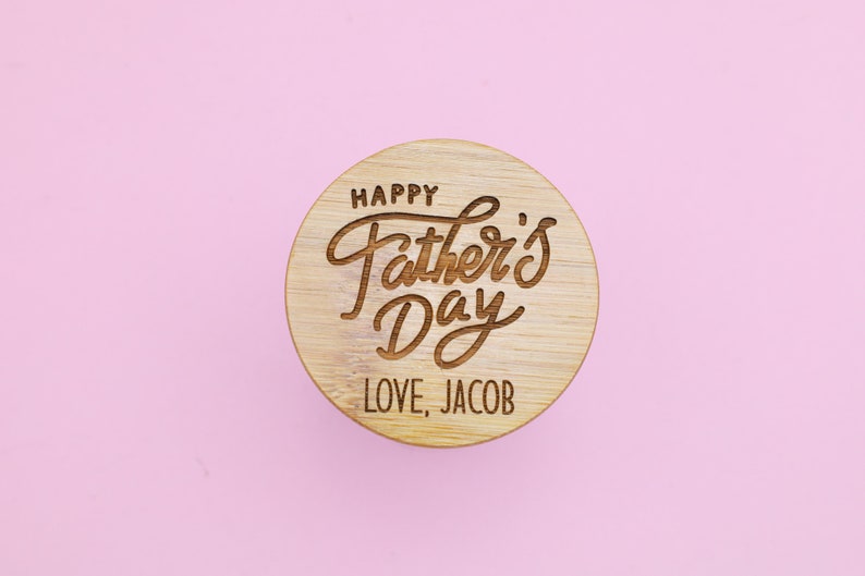 May include: A round wooden coaster with the text "Happy Father's Day" and "Love, Jacob" engraved on it.
