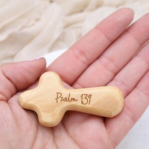 May include: A small wooden cross with the words "Psalm 139" engraved on it.