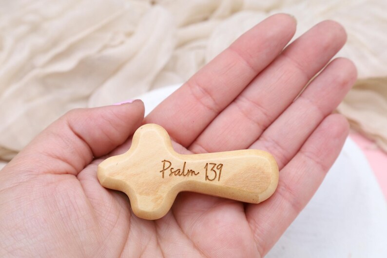 May include: A small wooden cross with the words "Psalm 139" engraved on it.