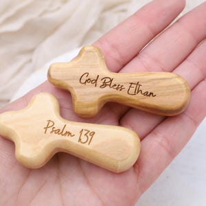 May include: Two wooden crosses with engraved messages. One cross reads "God Bless Ethan" and the other reads "Psalm 139".
