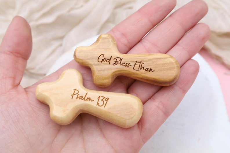 May include: Two wooden crosses with engraved messages. One cross reads "God Bless Ethan" and the other reads "Psalm 139".