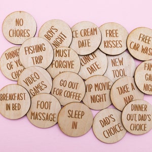 May include: Wooden tokens with various phrases written on them, such as "No Chores", "Free Kisses", "Fishing Trip", "Breakfast in Bed", and "Go Out for Coffee".
