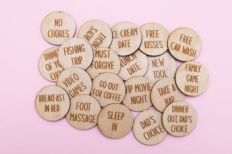 May include: Wooden tokens with various phrases written on them, such as "No Chores", "Free Kisses", "Fishing Trip", "Breakfast in Bed", and "Go Out for Coffee".