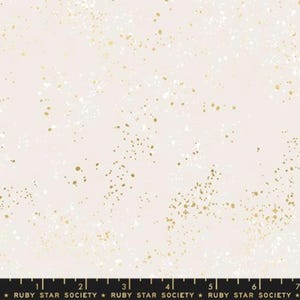 May include: A white fabric with a subtle speckled pattern in gold and white. The fabric has a soft, delicate feel and is perfect for crafting projects.