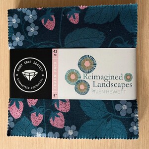 May include: A fabric charm pack featuring a dark teal floral and strawberry pattern. The pack is wrapped with a white band that reads "Reimagined Landscapes by JEN HEWETT." The pack is 5 inches in size and contains 42 pieces.