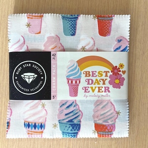 May include: A fabric charm pack featuring an ice cream cone pattern in pink, blue, and orange on a white background. The pack is wrapped with a label that reads "BEST DAY EVER" and "Ruby Star Society". Each square measures 5 inches.