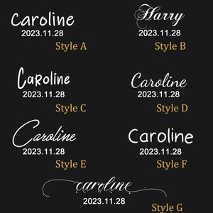 May include: Seven different styles of the name "Caroline" written in white cursive script on a black background. Each style is labelled with a letter from A to G. The date "2023.11.28" appears below each name.