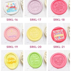 May include: A set of 27 different wax seal stamps featuring various birthday designs. The stamps are made of metal and have a variety of colors, including pink, blue, green, yellow, and orange. The designs include balloons, cakes, and other birthday-themed imagery. The text on the stamps includes "Happy Birthday" and "To You".