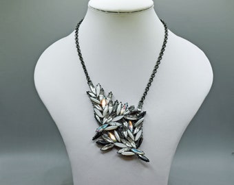Large Statement Necklace with clusters of crystal, aurora, black, pale grey and pearl marquise stones on a black chain.
