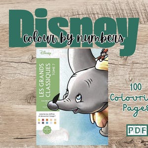 May include: A book cover for a Disney coloring book featuring Dumbo the elephant. The book is titled "Les Grands Classiques Tome 7" and has 100 coloring pages. The cover is blue and features a watercolor-style illustration of Dumbo.
