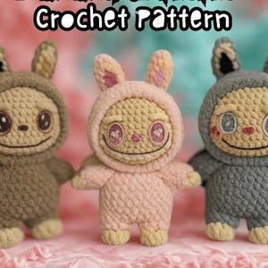 May include: Three handmade crochet dolls in a row, each with a bunny-like hood. The dolls are in shades of brown, pink, and gray, with smiling faces and large eyes. The text "Labubu/Zimomo Crochet Pattern" is at the top.