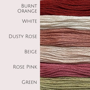 May include: Six spools of embroidery floss in different colors: burnt orange, white, dusty rose, beige, rose pink, and green.