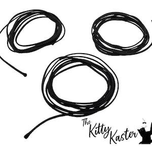 May include: Three spools of black cord, each wound into a circle.