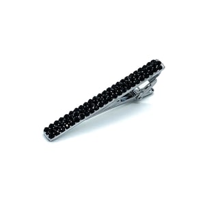 May include: A silver hair clip with a black crystal design. The clip is about 2 inches long and has a simple, elegant design.