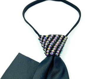 May include: A black satin tie with a black and iridescent crystal embellishment. The tie is designed to be worn as a clip-on.