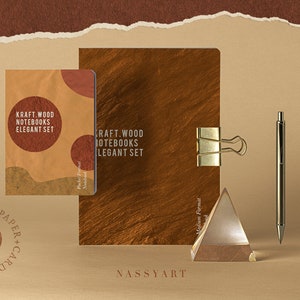 May include: Two kraft paper notebooks with the text "Kraft Wood Notebooks Elegant Set" on the cover. The notebooks are on a brown surface with a gold metal paperclip, a glass prism, and a silver pen.