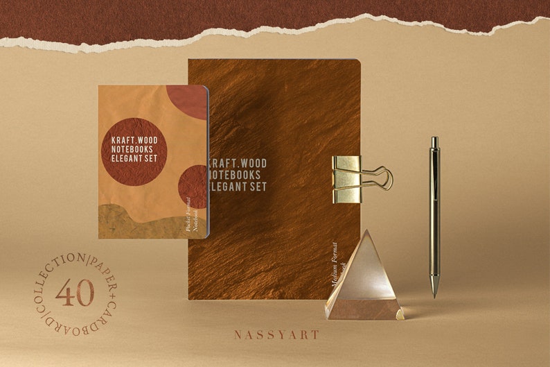 May include: Two kraft paper notebooks with the text "Kraft Wood Notebooks Elegant Set" on the cover. The notebooks are on a brown surface with a gold metal paperclip, a glass prism, and a silver pen.