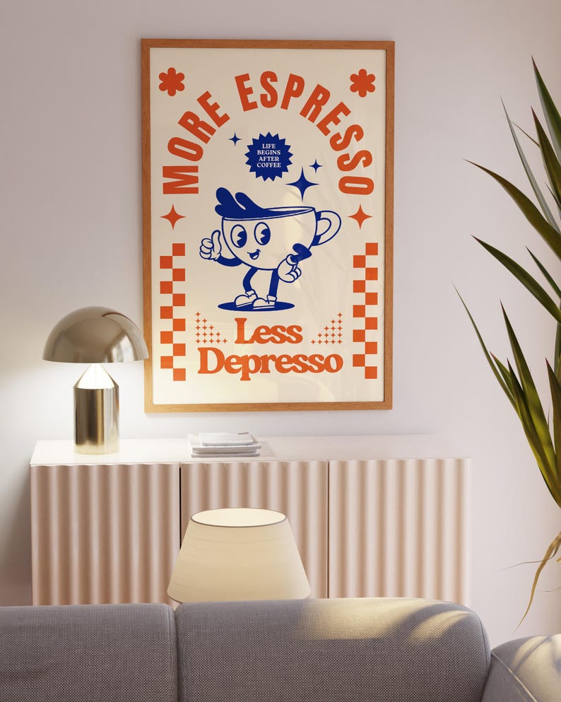 May include: A framed poster with a retro design. The poster features a cartoon coffee cup with the text "More Espresso, Less Depresso." The color scheme includes cream, orange, and blue. The poster is in a wooden frame.
