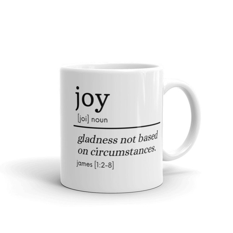 May include: White ceramic mug with black text that reads "joy [joi] noun gladness not based on circumstances. james [1:2-8]"
