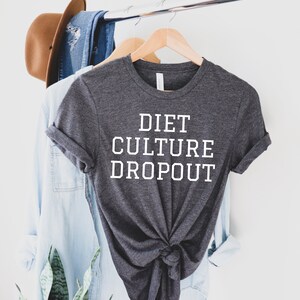 May include: A dark gray t-shirt with the text "DIET CULTURE DROPOUT" printed in white.