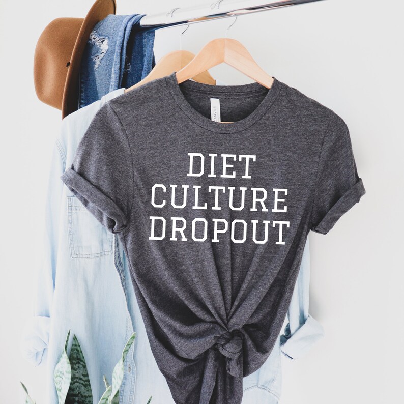May include: A dark gray t-shirt with the text "DIET CULTURE DROPOUT" printed in white.