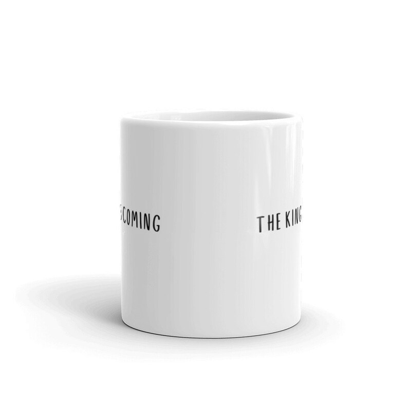 May include: White ceramic mug with black text that reads "Becoming the King".