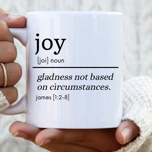 May include: White ceramic mug with black text that reads "joy [joi] noun gladness not based on circumstances. james [1:2-8]"